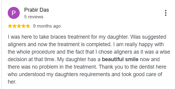 Google review describing aligner treatment and a completed smile at Dontia Care Clinic